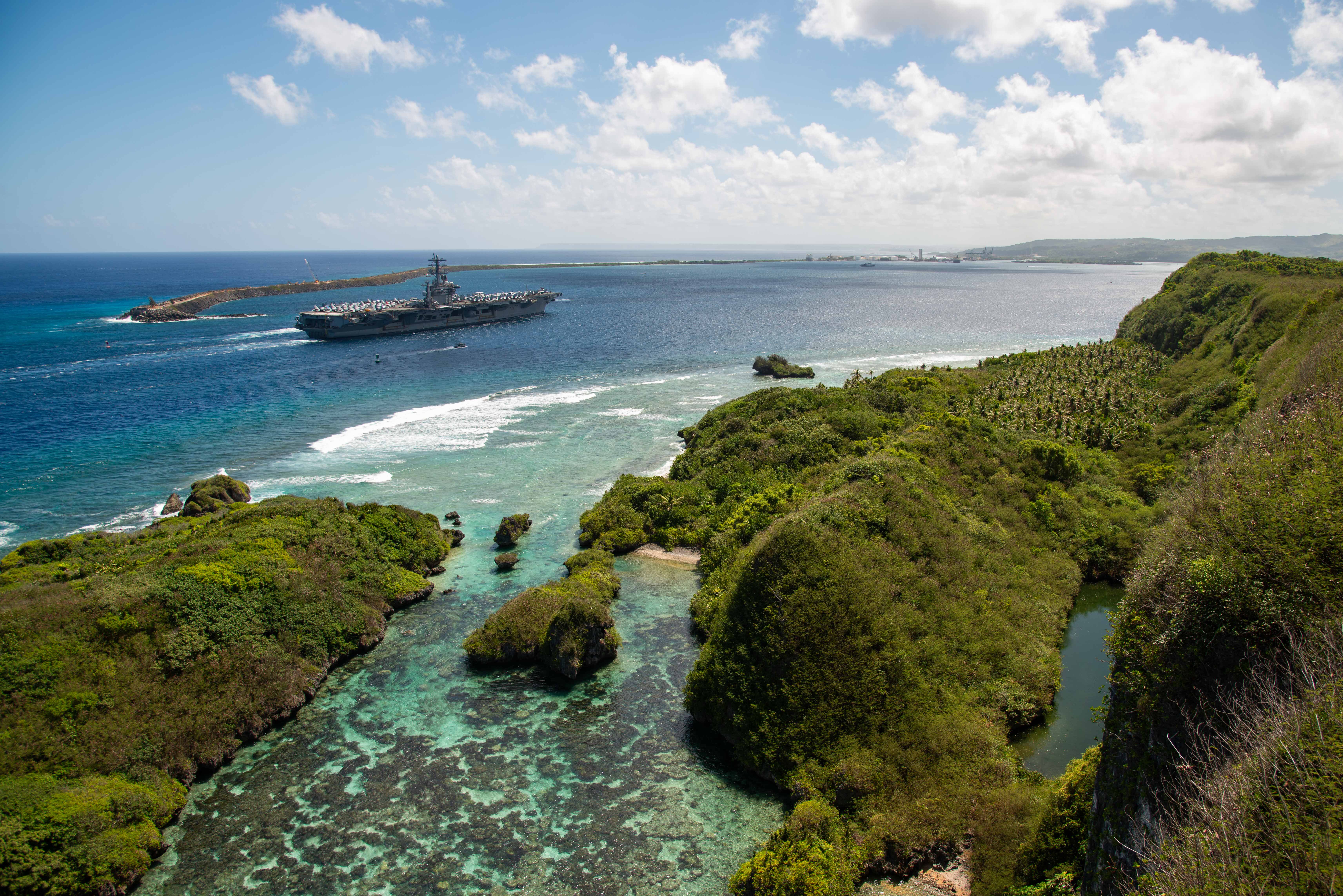 This is an image of a United States Navy aircraft carrier arriving in Apra Harbor, Guam.